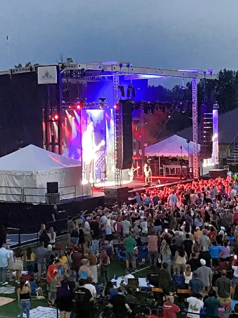 APEX 4240 GEN3 at night with LED walls and a full festival crowd